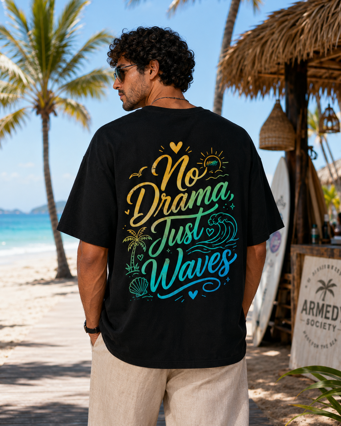 Tricou negru oversized No Drama Just Waves cu grafica mare pe spate, purtat in decor tropical