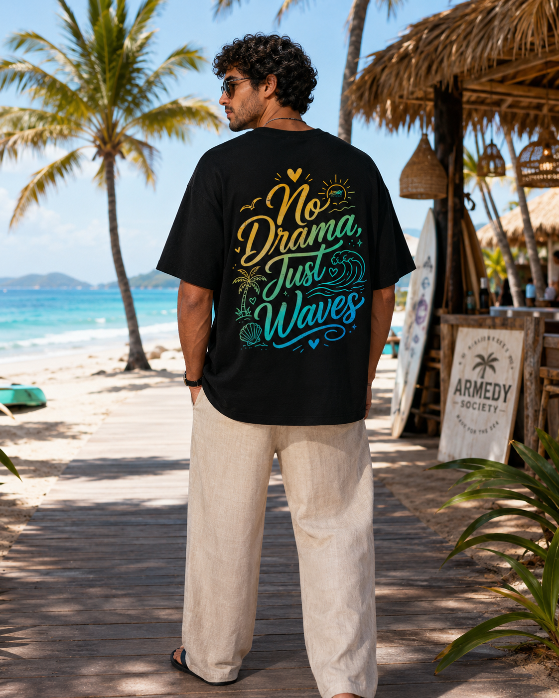 Tricou negru oversized No Drama Just Waves cu grafica mare pe spate, purtat in decor tropical